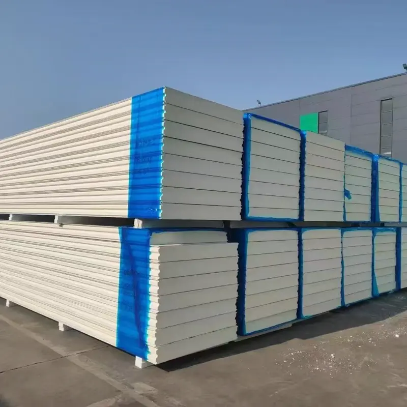 Industrial warehouse under construction — purple steel frame with PU sandwich panel envelope