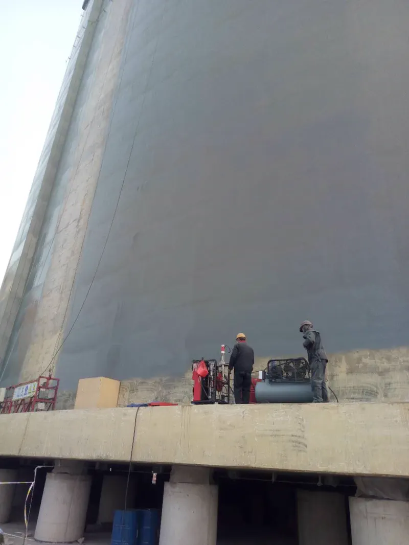 Tank polyurea spray equipment — close-up of spray nozzle in action